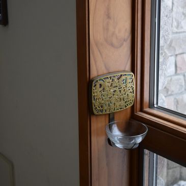 A peace plaque mounted beside a doorway in the church